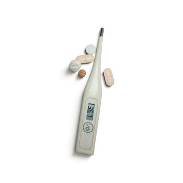 Vertical shot of digital thermometer showing normal temperature with pills on white background