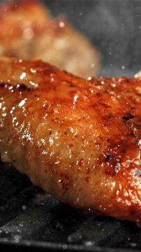 Chicken wings are fried in a pan. Filmed on a high-speed camera at 1000 fps. High quality FullHD footage