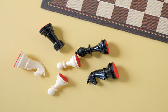Chess pieces scattered out side board game.