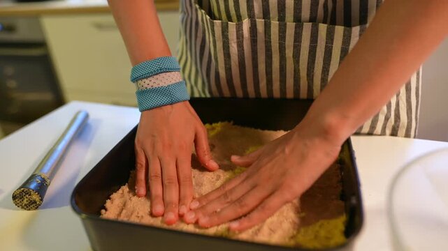 Kitchen scene with student evening out pastry filling carefully