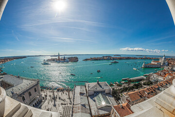 Fototapeta premium VENICE, ITALY - MARCH 16, 2023: Venice panorama South-East from the height of Campanile San Marco tower, with Piazzetta San Marco in foreground, sea and venetian island in background.
