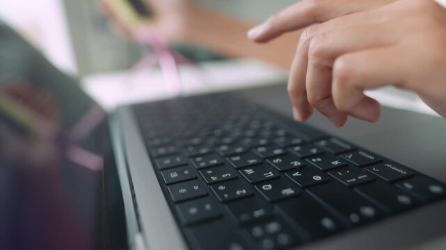 Concentrated programmer debugging software using laptop and keyboard