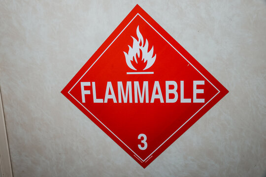 Flammable Hazard Warning Sign on Industrial Container &ndash; Red Safety Label for Dangerous Materials