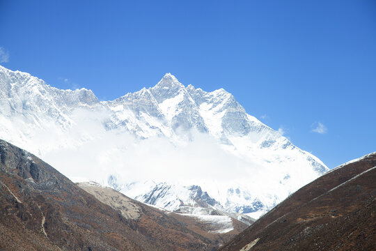 Majestic snow-capped Himalayan mountains under clear blue sky in Nepal's stunning landscape