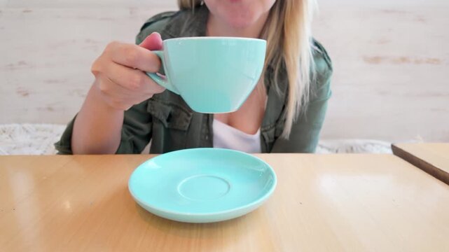 Woman enjoying hot drink at cafe shop - Relaxing lifestyle and coffee break concept