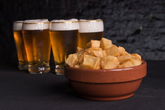 Craft beer and fries on dark background