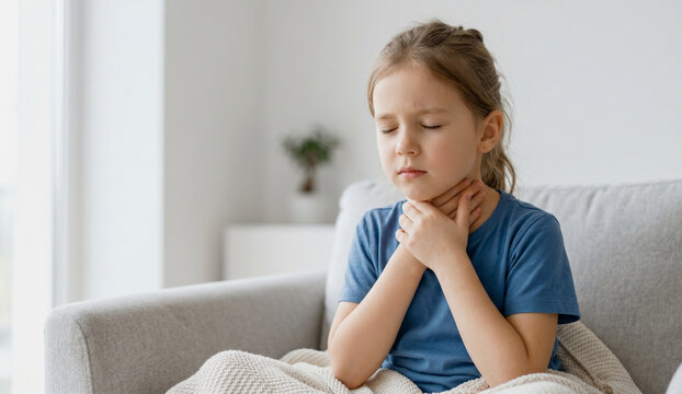 Sick little girl holding her throat 