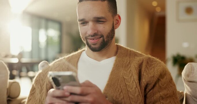 Phone, relax and happy man in home for online response, social media or check profile at living room. Mobile, sofa and person with app for communication on forum, smile or post update with message