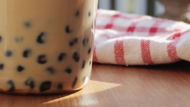 Bubble milk tea with black tapioca in plastic glass, supermarket chinese drink, tasty dessert, close up macro. 