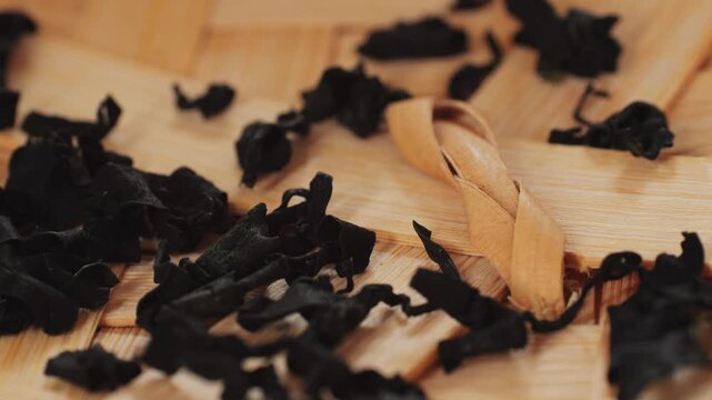 Dried wakame seaweed on a kitchen table. Dry laminaria, asian dish close up.