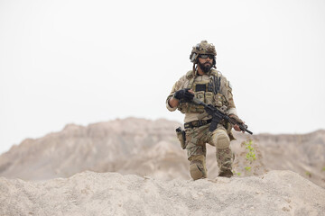 Fototapeta premium Soldier guarding the area on the mountain