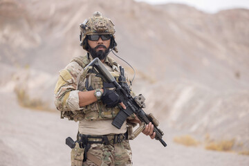 Fototapeta premium Soldier guarding the area on the mountain