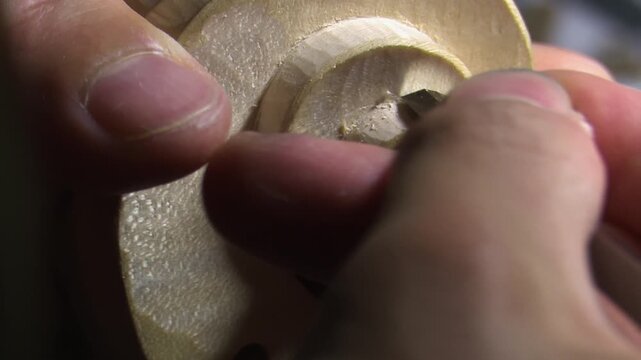 Bilbao, spain; may 21 2022: luthier hand carving a violin scroll with a chisel