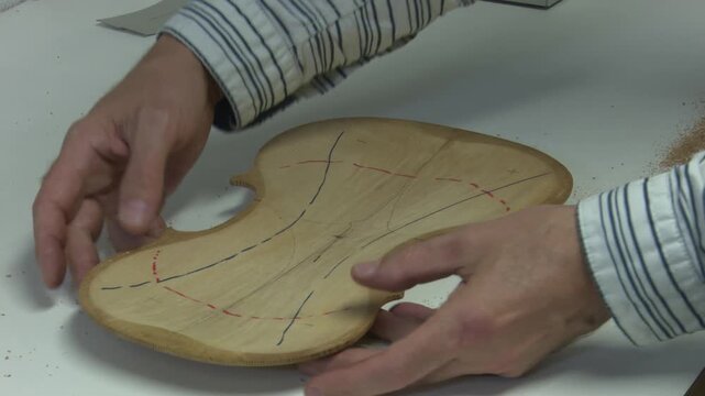 Bilbao, spain; may 21 2022: luthier crafting violin backplate in workshop