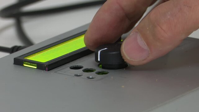 Bilbao, spain; may 21 2022: hand adjusting knob on electronic control panel