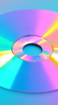 This shows a display of CDs reflecting light in many colors. The camera moves around them to show different angles and effects. Light plays on the shiny surfaces creating interesting visuals