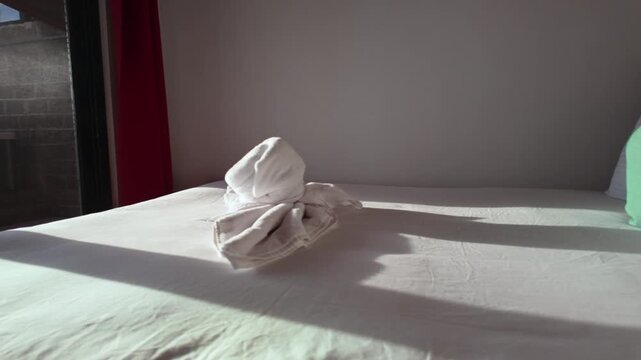 Elegant hotel bedroom with folded towel art