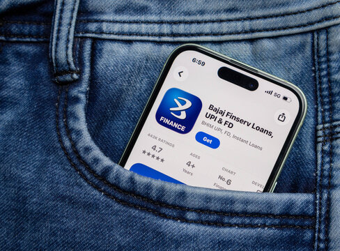 Smartphone showing the bajaj finserv app store page inside a blue denim jeans pocket, representing mobile finance and digital banking