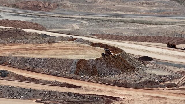 Zoom aerial close up shot of mining operations dump truck