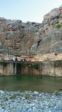 Flowing stream at Wadi Tanuf in Nizwa with clear water, rocks and canyon walls showcasing Omani valley nature. Nizwa, Oman - May 4 2026