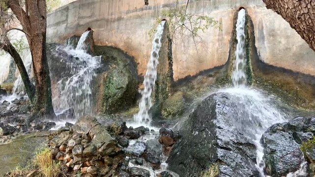 Description (للنسخ مباشرة):
Waterfalls at Wadi Tanuf in Nizwa with flowing water over rocks and trees, showcasing Omani nature and landscape. Nizwa, Oman - June 4 2026
