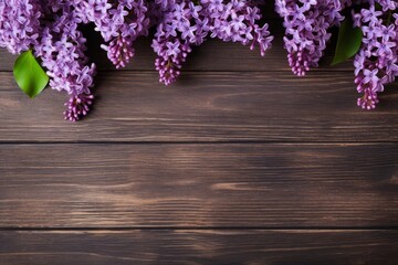 Fototapeta premium Purple lilac blossoms providing a floral border on dark wooden planks