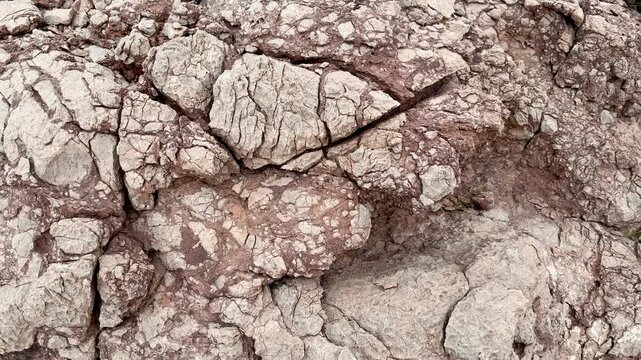 Weathered rock texture with natural cracks and geological patterns in a mountain landscape. Al Hamra, Oman - May 27, 2026