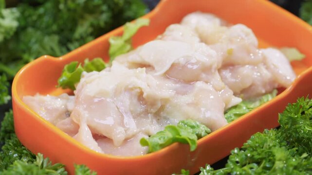 Hot pot ingredients: raw chicken breast and chicken pieces with bones