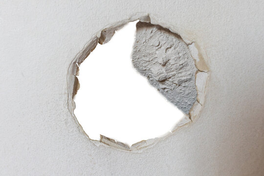 A hole with a transparent bottom in a drywall surface