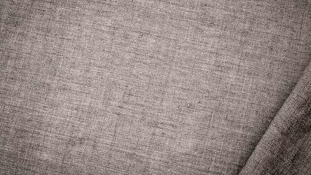 Close up view of gray fabric texture showing weave patterns from different angles in bright light
