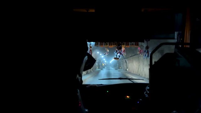 night bus journey through illuminated road tunnel with passenger silhouettes