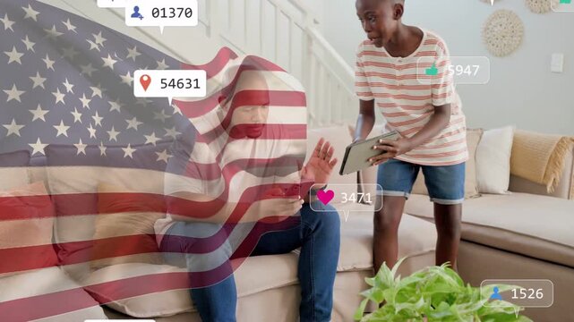 dad tapping phone, social icons growing over US flag overlay as son showing tablet, checking likes
