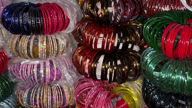 stacked multicolor bangles arranged in street shop during festive shopping season
