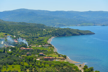 Fototapeta premium Scenic View of Lush Molyvos Coastline with Blue Sea and Hills in Greece