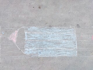 Chalk drawing of a pencil on concrete surface captures childhood creativity © IbragimovN