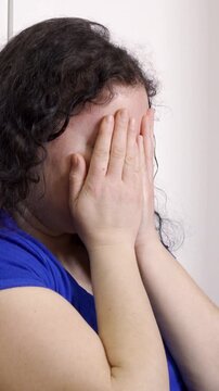 Upset problem woman with head in hands sitting on floor concept for bullying, depression stress or frustration at workplace