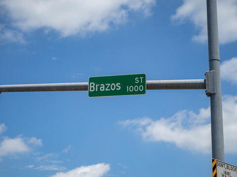 Brazos Street Sign on Traffic Light With Cloudy Blues in Austin, Texas