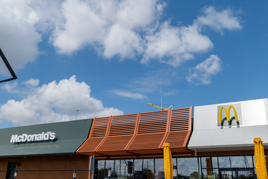 Lutsk, Ukraine &ndash; May 13, 2026: McDrive at McDonald's features a modern design under a blue sky with clouds and construction work taking place nearby