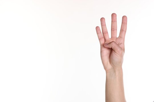 Man showing number four with fingers on white background, closeup. Space for text