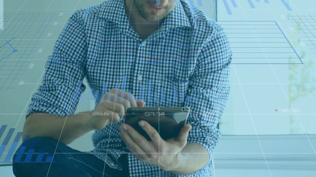 Man tapping tablet by window, initiating animated charts while analyzing business metrics, pausing