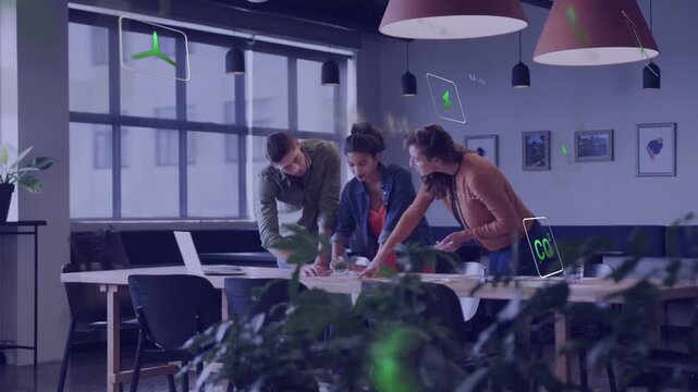Project team pointing at layout on meeting table, causing green AR icons, organizing design