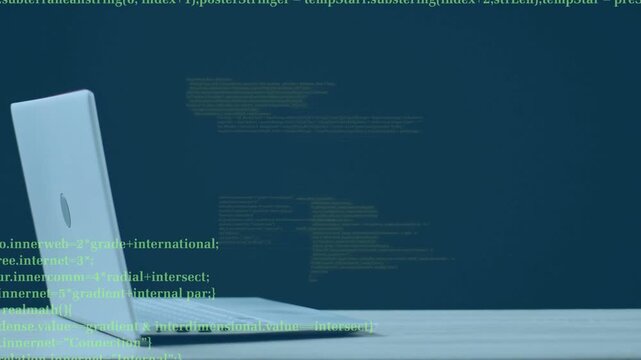 On start green code emerging beside laptop, shifting, trailing, dropping, showing data