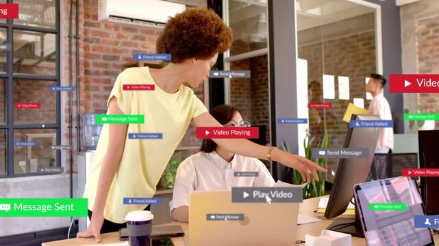 Standing woman leaning over peer, pointing at monitor and showing notifications for business review