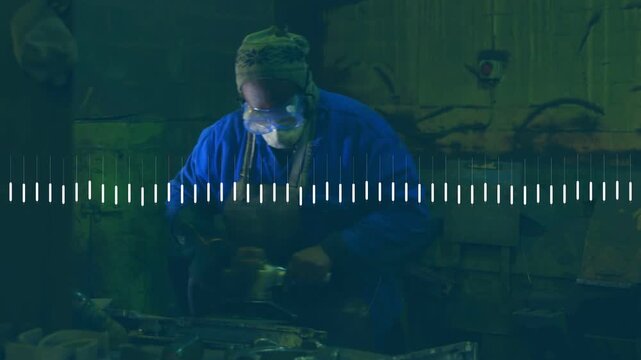 Man picking up grinder and sanding metal on workbench, shaping part, waveform overlaying center