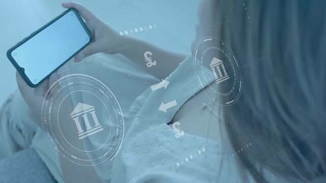 Woman reclining tilting phone while monitoring funds, finance HUD animating bank icons and &euro;$&yen;&pound;
