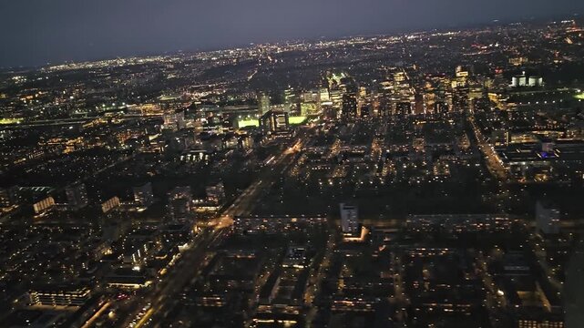 The plane approaches Schiphol Airport for landing. A view of Amsterdam in the late evening. Flight Krakow to Amsterdam. View from the cabin.

