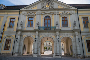 Fototapeta premium Ornate historic palace entrance with arches, windows, and crest in springtime Stuttgart.