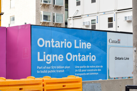 Colourful construction barrier for the Ontario Line featuring official government signage and project information, shown in an urban Toronto street setting in May 2026
