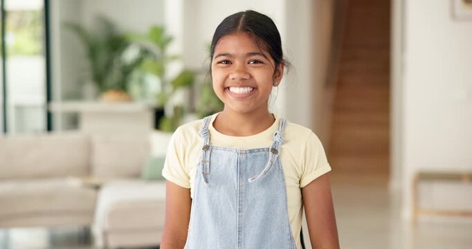 Happy, laugh and face of child in home to relax on weekend, holiday and free time in living room. Excited, humor and portrait of girl with funny joke, good mood and confidence for positive attitude
