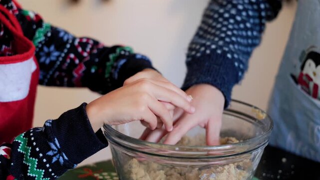 Children's hands mixing cookie dough at home